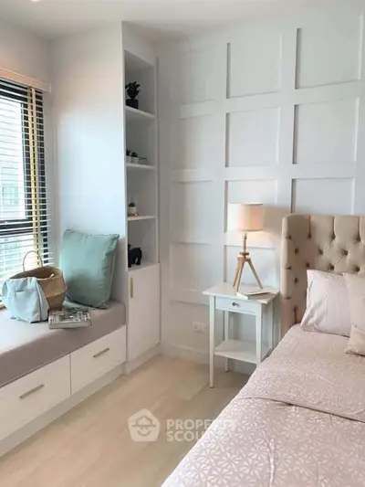 Cozy bedroom with elegant panel wall, soft pink bedding, and built-in window seat with storage.
