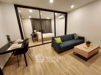 Modern open-plan living room with stylish furniture and wooden flooring