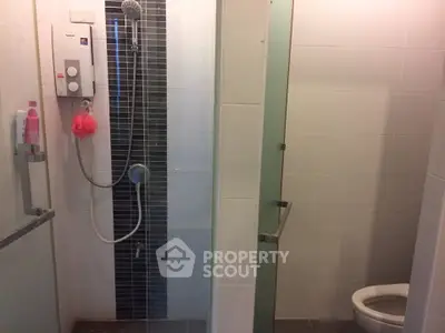 Modern bathroom with glass shower enclosure and sleek fixtures