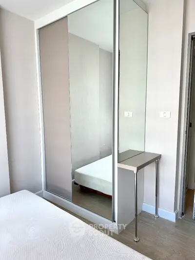 Modern bedroom with mirrored closet and minimalist decor