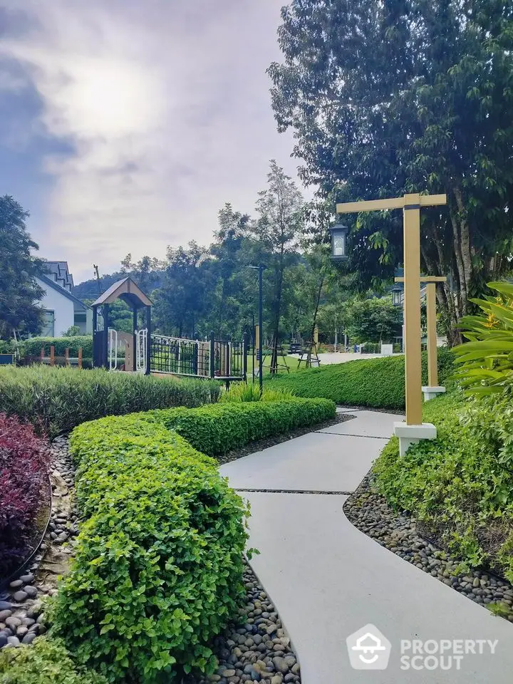 Beautiful garden pathway in a serene residential community with lush greenery and modern landscaping.