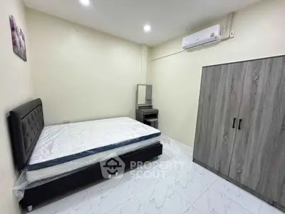 Spacious bedroom with modern furniture and air conditioning