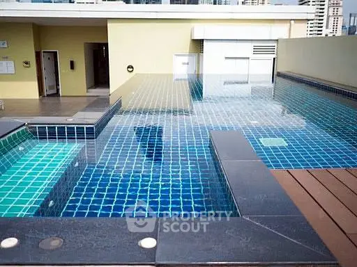 Luxurious rooftop pool with modern design and city views, perfect for relaxation and leisure.