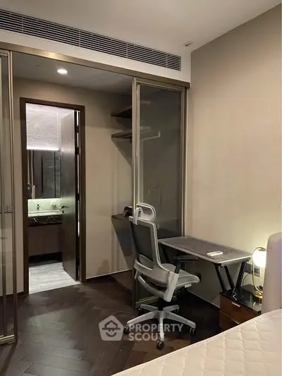 Modern bedroom with study area and ensuite bathroom in luxury apartment