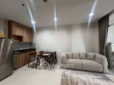 Modern open-layout living room with cozy sofa and dining area in stylish apartment.