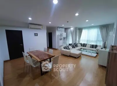 Spacious modern living room with wooden flooring and elegant furniture