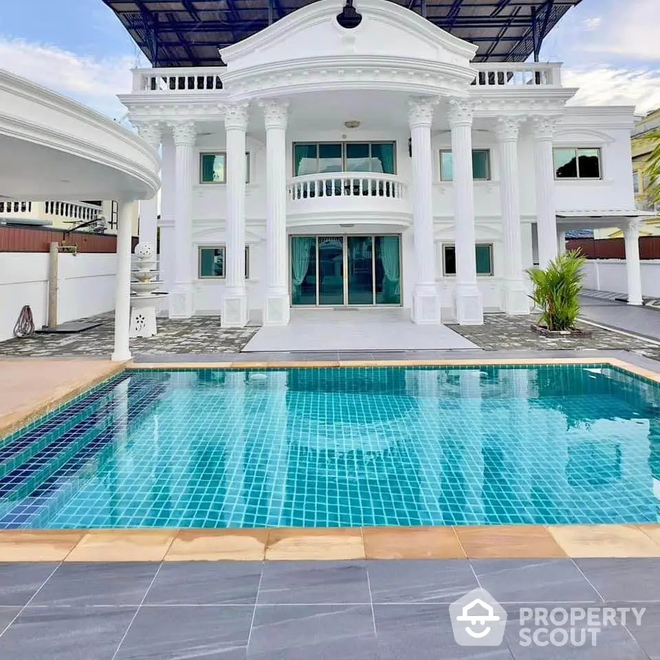 Luxurious mansion with grand columns and private pool, perfect for upscale living.