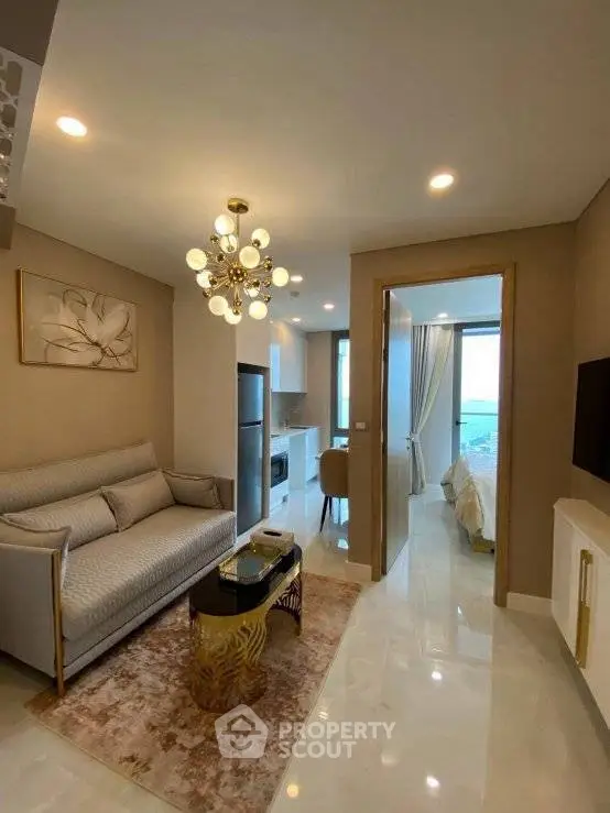 Luxurious modern living room with elegant decor and open view to bedroom