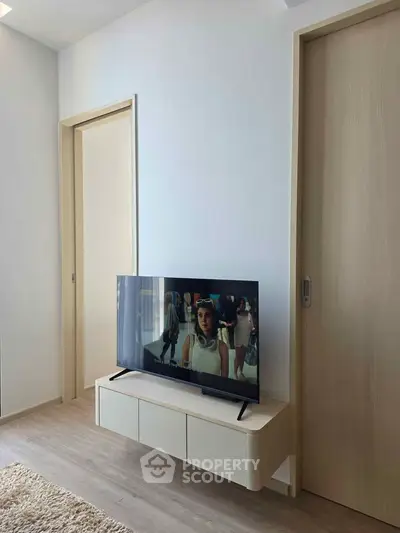 Modern living room with sleek TV stand and wooden flooring
