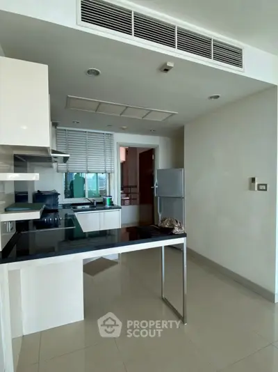 Modern kitchen with sleek design and stainless steel appliances in a contemporary apartment.