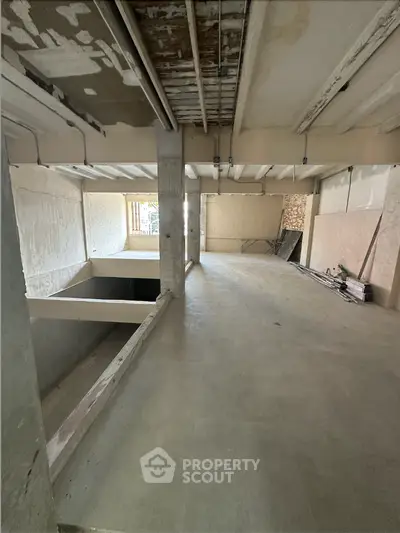 Spacious unfinished interior space with potential for customization and renovation.