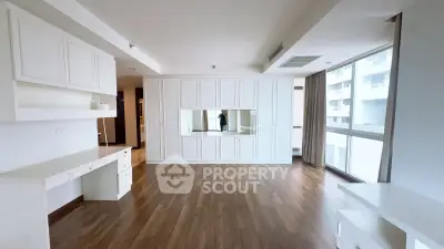 Spacious modern living room with wooden flooring and large windows