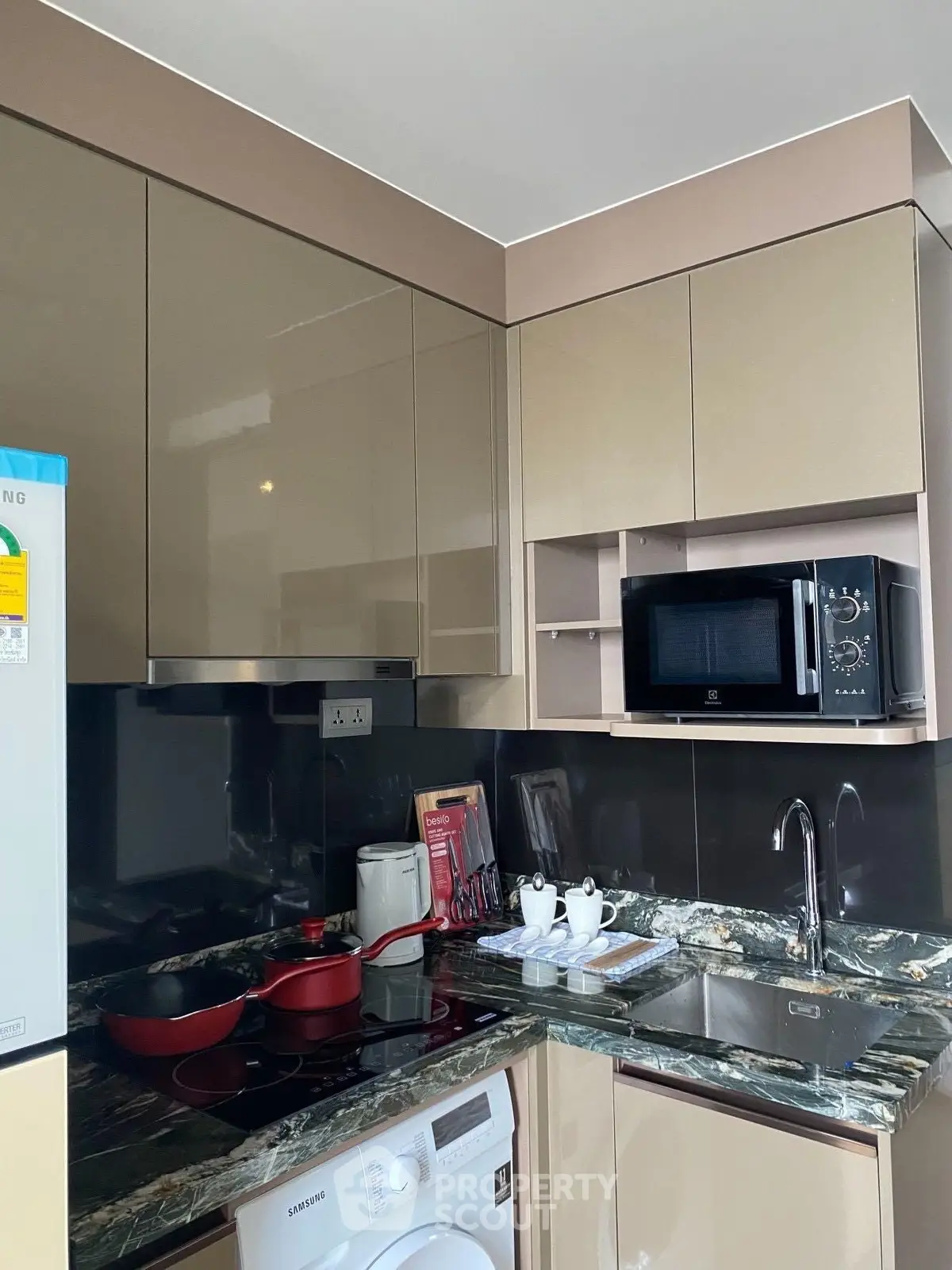 Modern kitchen with sleek cabinets, granite countertops, and built-in appliances.