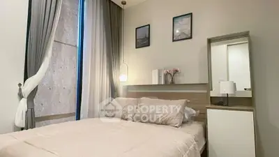 Cozy bedroom with modern decor and natural light, perfect for relaxation.