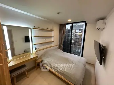 Modern bedroom with balcony view, featuring sleek design and ample natural light.