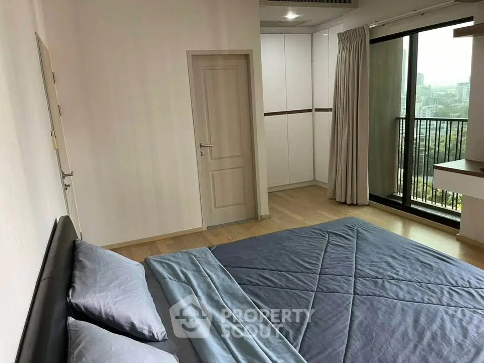 Spacious bedroom with city view and modern furnishings