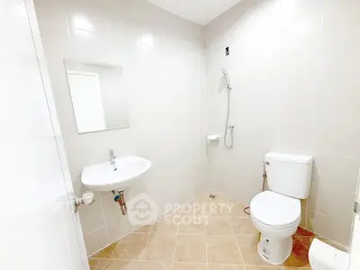 Spacious modern bathroom with sleek fixtures and tiled walls, perfect for a contemporary home.