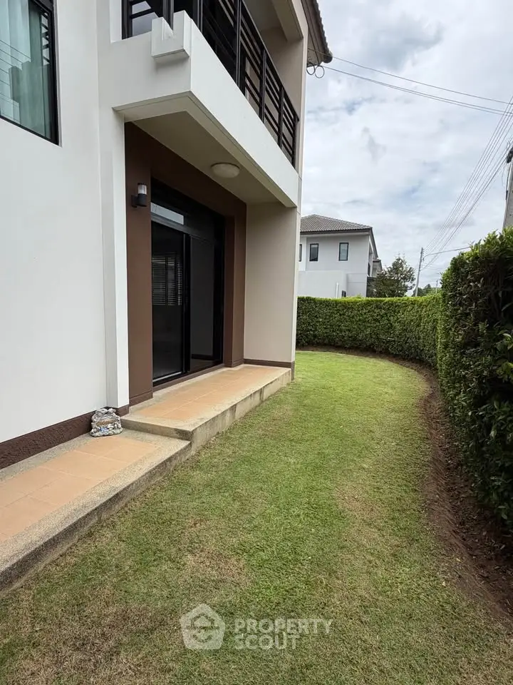 Charming residential exterior with lush green lawn and modern architecture.