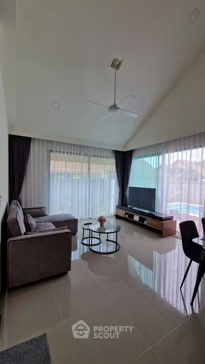 Spacious living room with modern decor and large windows for natural light.