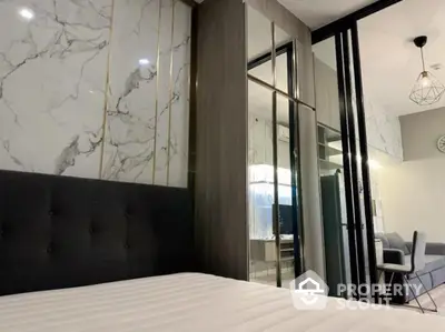 Modern bedroom with stylish decor and mirrored wardrobe