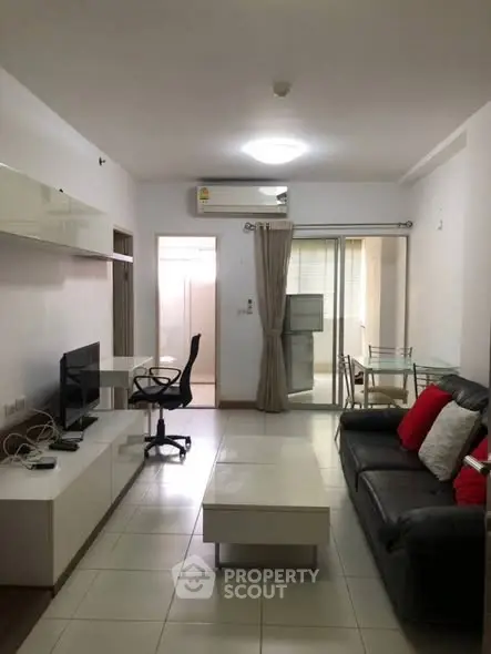 Modern living room with sleek furniture and balcony access