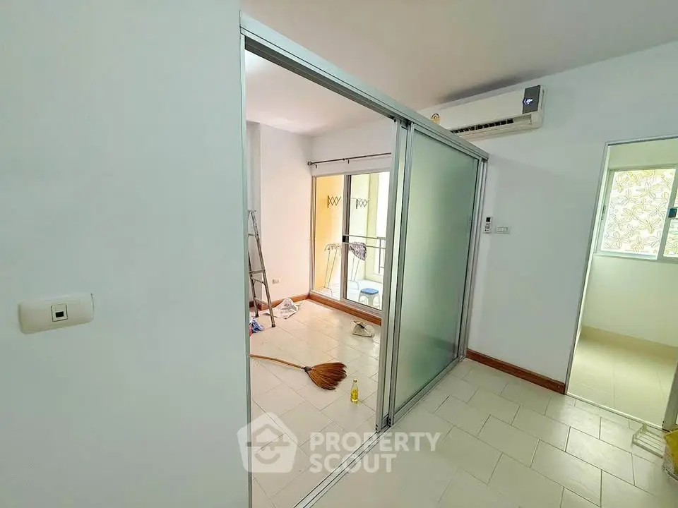 Spacious room with sliding glass doors and air conditioning, ideal for modern living.