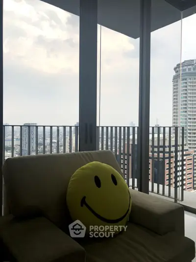 Modern balcony with city skyline view and cozy seating area.