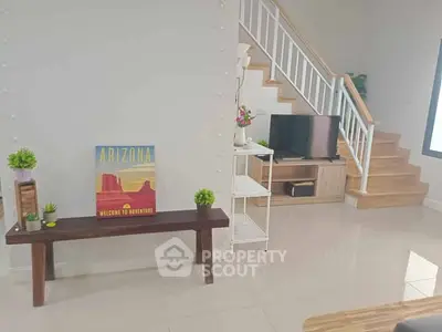 Modern living room with stylish staircase and Arizona-themed decor, perfect for cozy gatherings.