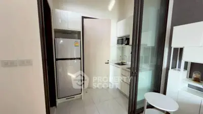 Modern compact kitchen with sleek appliances and minimalist design