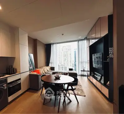 Modern open-plan living room with city view, stylish furniture, and sleek kitchen design.