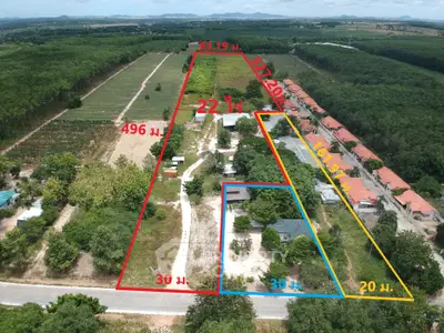 Expansive aerial view of subdivided land plots in lush countryside setting.