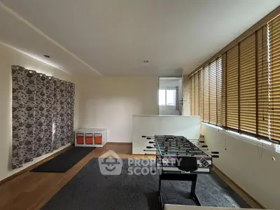 Spacious room with foosball table and large windows for natural light