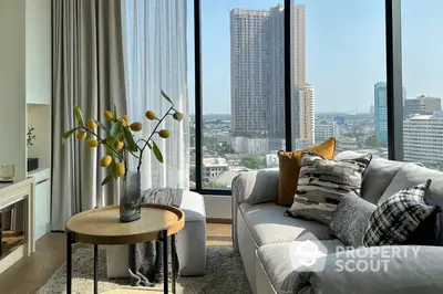 Sunlit spacious living room with floor-to-ceiling windows offering a panoramic city view, modern furnishings, and a cozy ambiance.