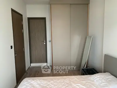 Modern bedroom with sleek wardrobe and minimalist decor