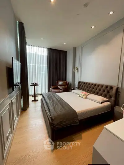 Luxurious bedroom with elegant decor and large window for natural light.