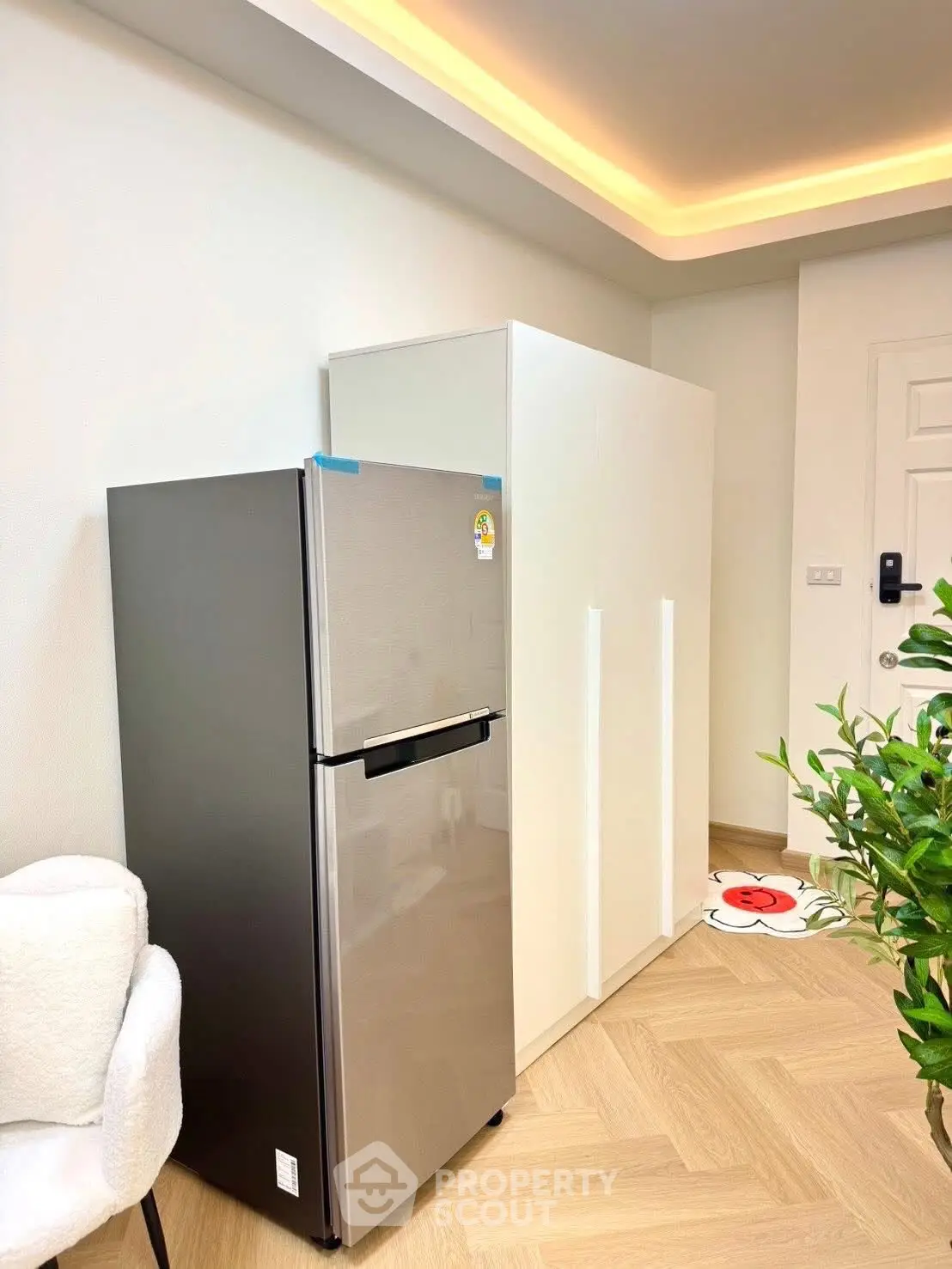 Modern kitchen with sleek fridge and stylish cabinetry in a bright interior.