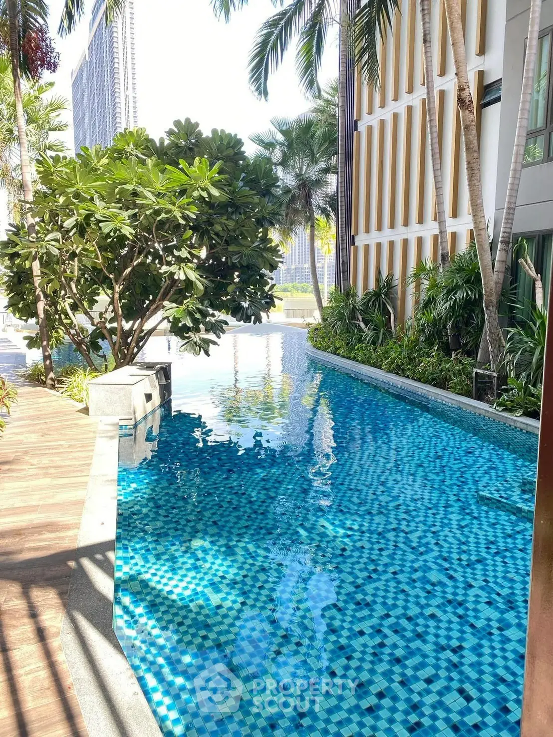 Luxurious poolside view with lush greenery and modern architecture