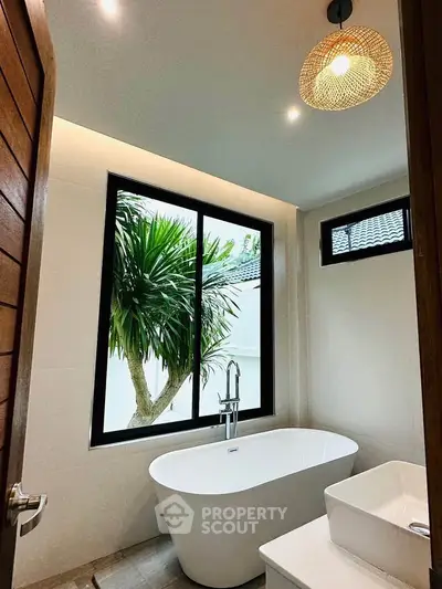 Luxurious bathroom with freestanding bathtub and large window view