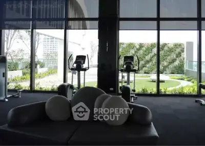 Luxurious modern living room with floor-to-ceiling windows and garden view