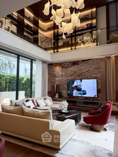 Luxurious modern living room with high ceilings and elegant chandelier
