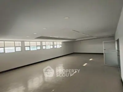 Spacious empty room with large windows and polished floor, ideal for customization.