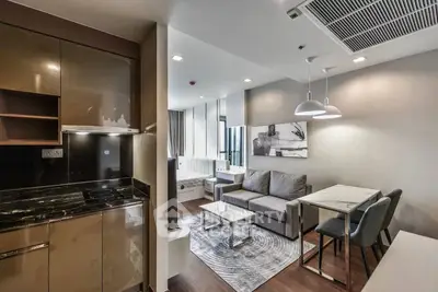 Modern open-plan living room with sleek kitchen and stylish decor