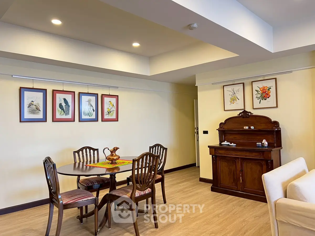 Charming dining area with elegant wooden furniture and artistic wall decor.