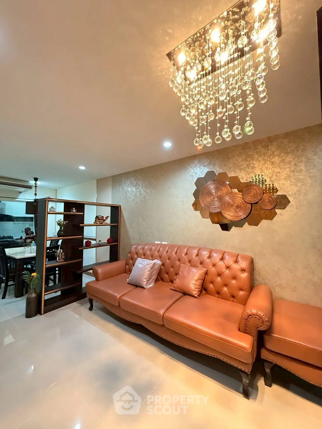 Luxurious living room with elegant chandelier and stylish leather sofa