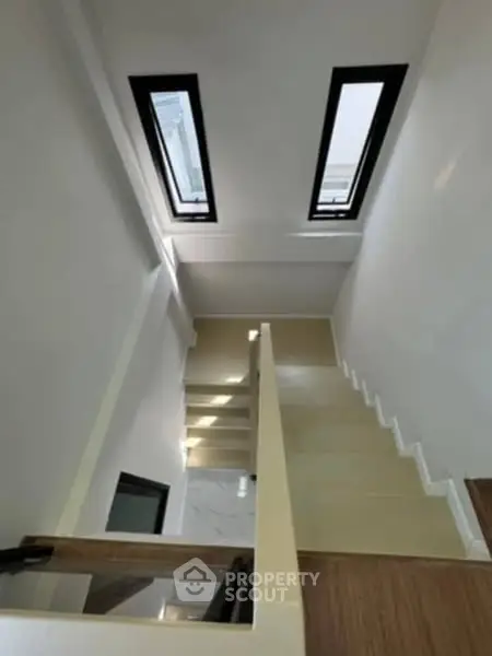 Modern staircase with skylights in contemporary home