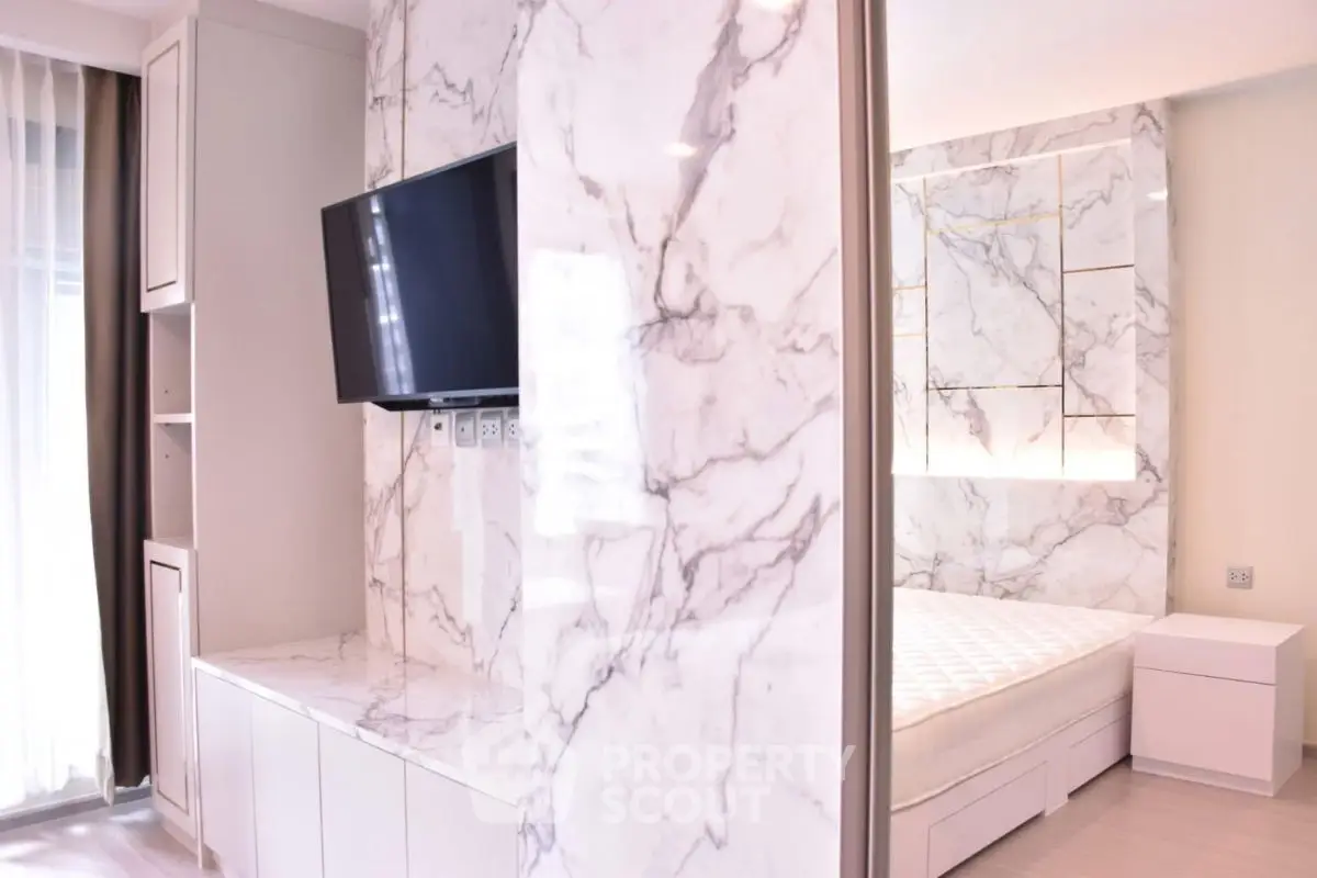 Luxurious modern bedroom with marble accents and built-in TV