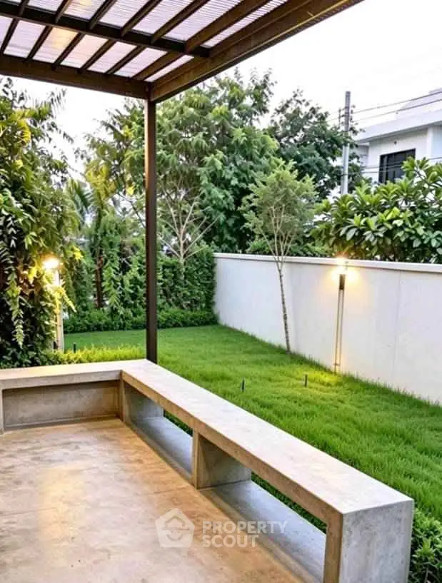 Modern outdoor patio with lush garden view and sleek concrete seating area.