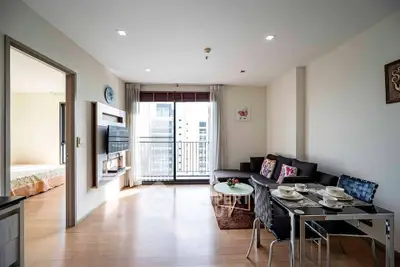 Modern living room with open layout and balcony view in a stylish apartment