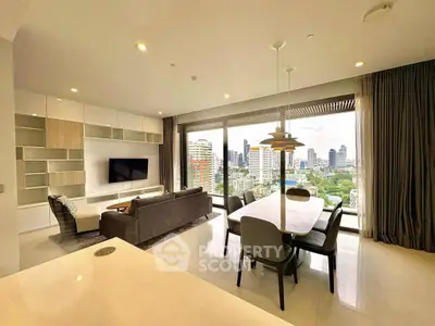 Luxurious open-plan living room with stunning city view and modern furnishings.