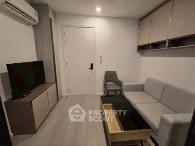 Modern living room with sleek furniture and neutral tones, featuring a cozy sofa and wall-mounted storage.